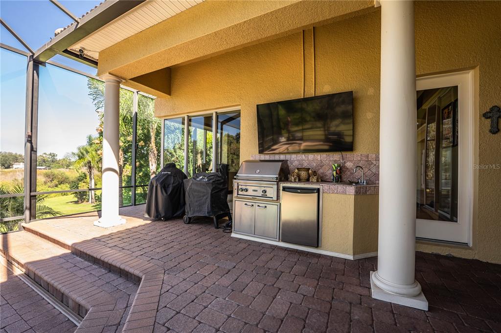 2918 Clubhouse Road Lakeland, FL 33812 - Photo 39 of 47 a kitchen with stainless steel appliances granite countertop a refrigerator a stove and a wooden cabinets