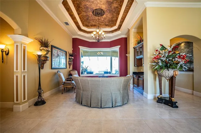 a view of a dining room with furniture and a chandelier