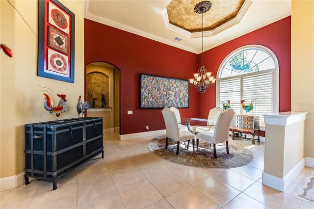 a view of a dining room with furniture and a chandelier