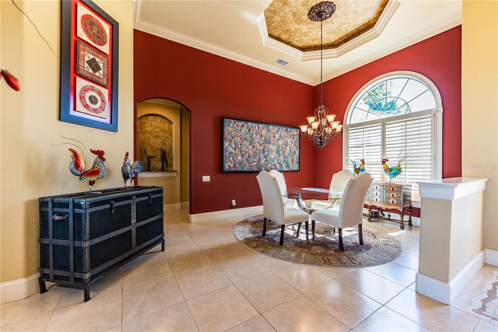 2918 Clubhouse Road Lakeland, FL 33812 - Photo 7 of 47 a view of a dining room with furniture and a chandelier