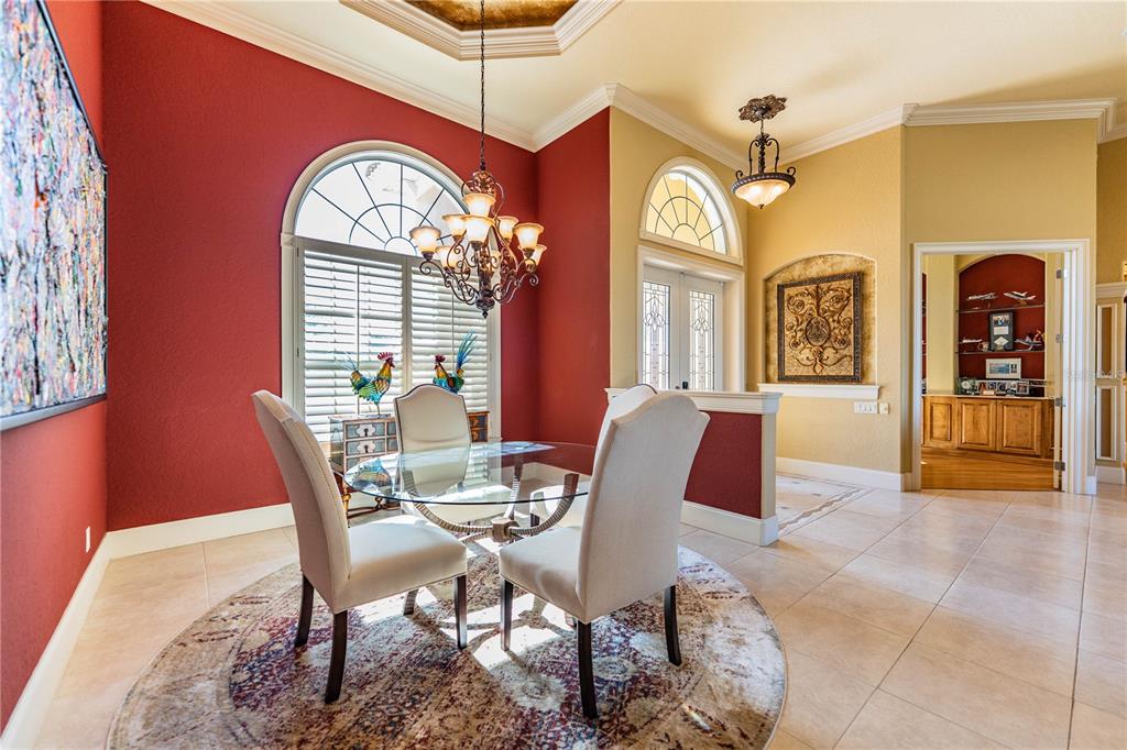 2918 Clubhouse Road Lakeland, FL 33812 - Photo 8 of 47 a view of a dining room with furniture and a chandelier