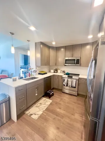 a kitchen with stainless steel appliances granite countertop a refrigerator sink and microwave