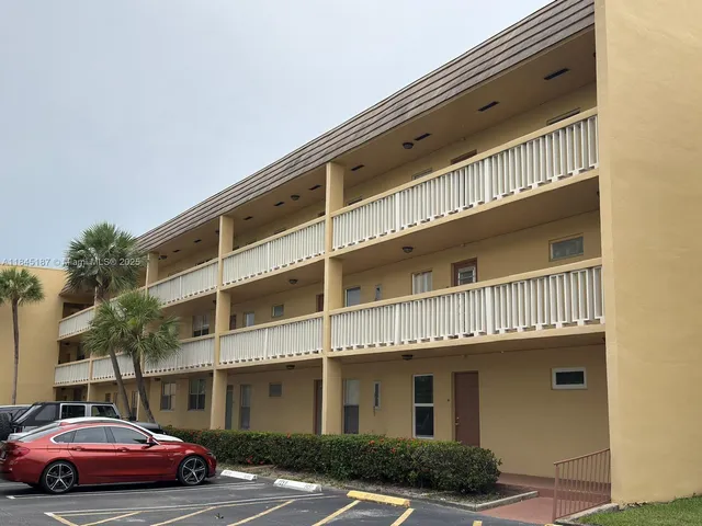 a front view of a building with parking space and parking