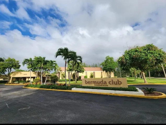 a view of a swimming pool and trees in the background