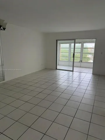 a view of an empty room and a window