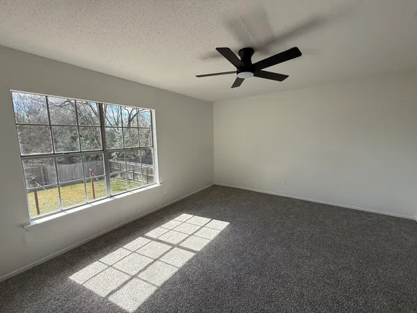 a view of an empty room and a window