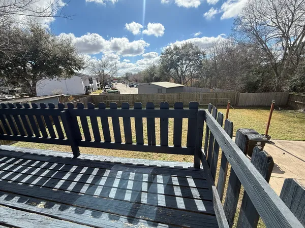 a view of a balcony with wooden floor