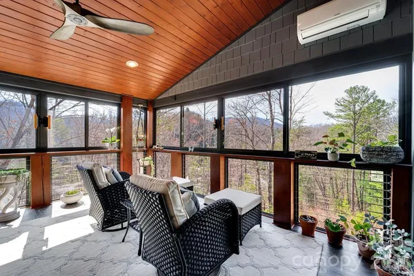 a dining room with furniture and a large window