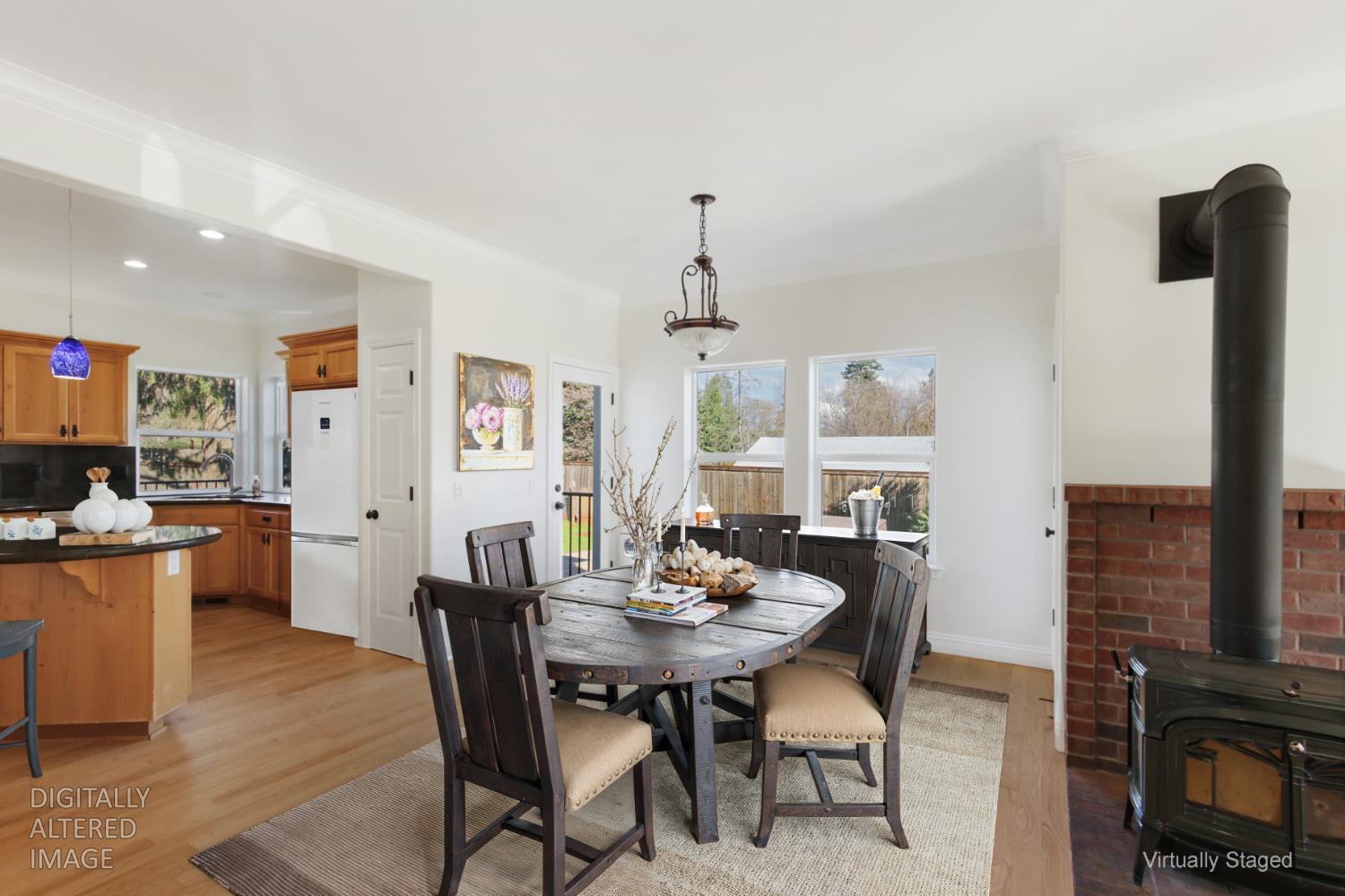 12930 Ridge Road Grass Valley, CA 95945 - Photo 12 of 62 a dining room with furniture a chandelier and wooden floor