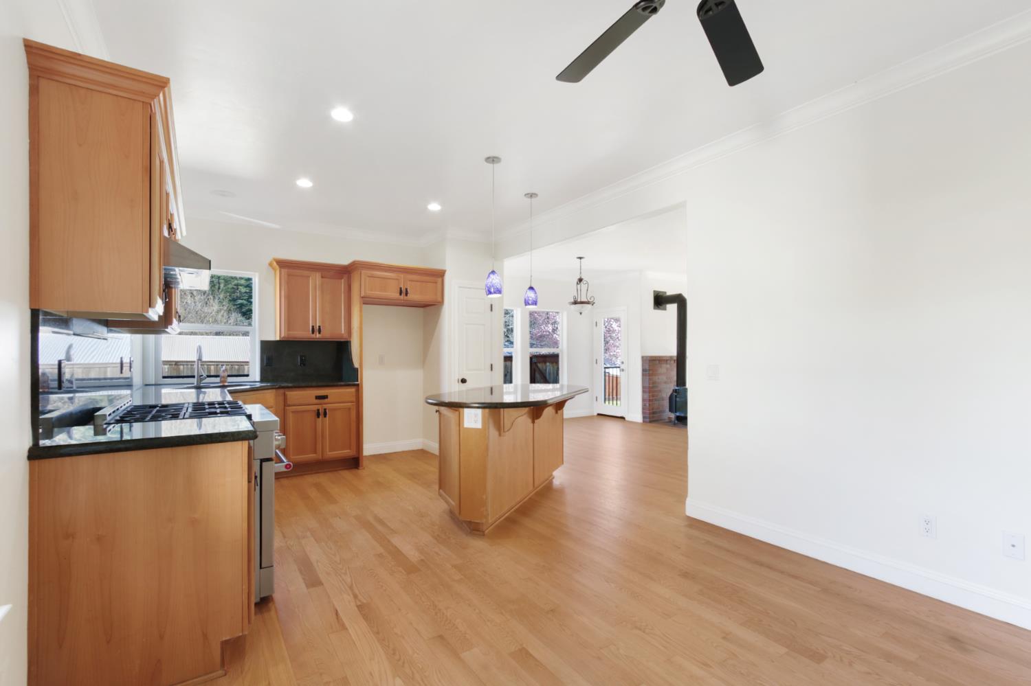 12930 Ridge Road Grass Valley, CA 95945 - Photo 16 of 62 a kitchen with stainless steel appliances kitchen island hardwood floor sink and stove