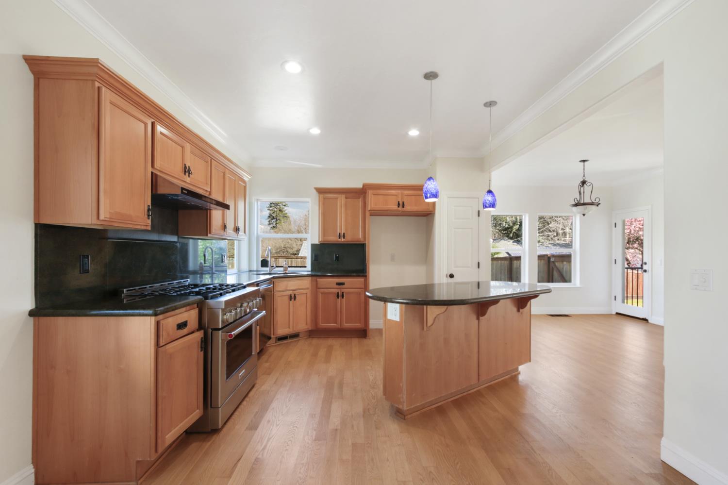 12930 Ridge Road Grass Valley, CA 95945 - Photo 19 of 62 a large kitchen with stainless steel appliances wooden floors and wooden cabinets