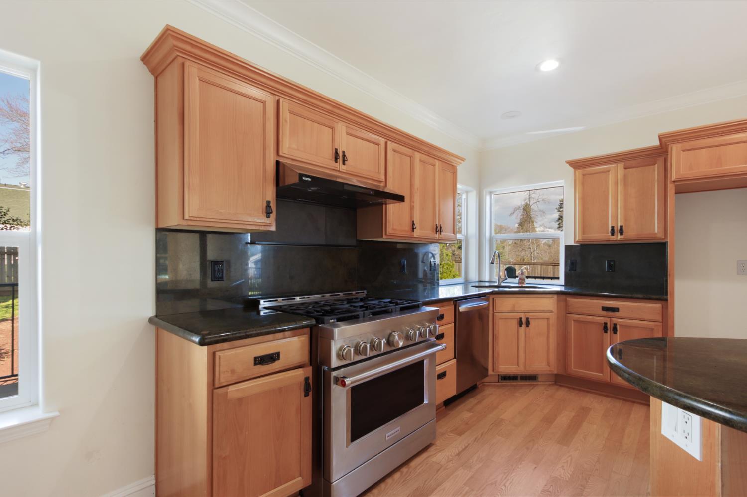 12930 Ridge Road Grass Valley, CA 95945 - Photo 20 of 62 a kitchen with stainless steel appliances granite countertop a stove a sink and a microwave