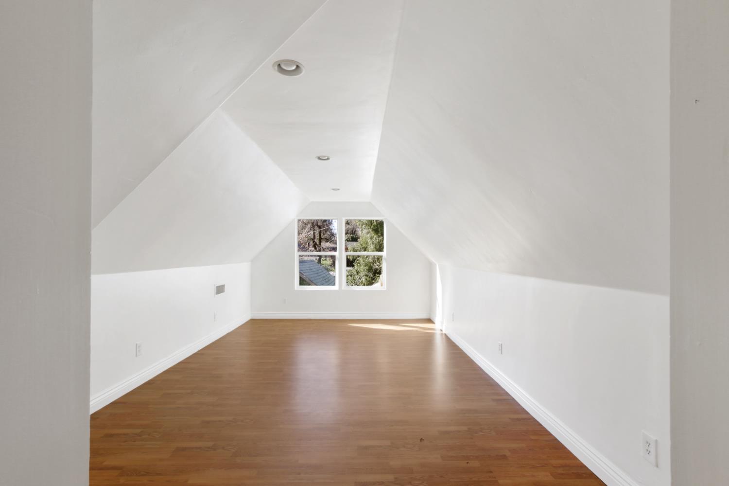 12930 Ridge Road Grass Valley, CA 95945 - Photo 27 of 62 an empty room with wooden floor and windows