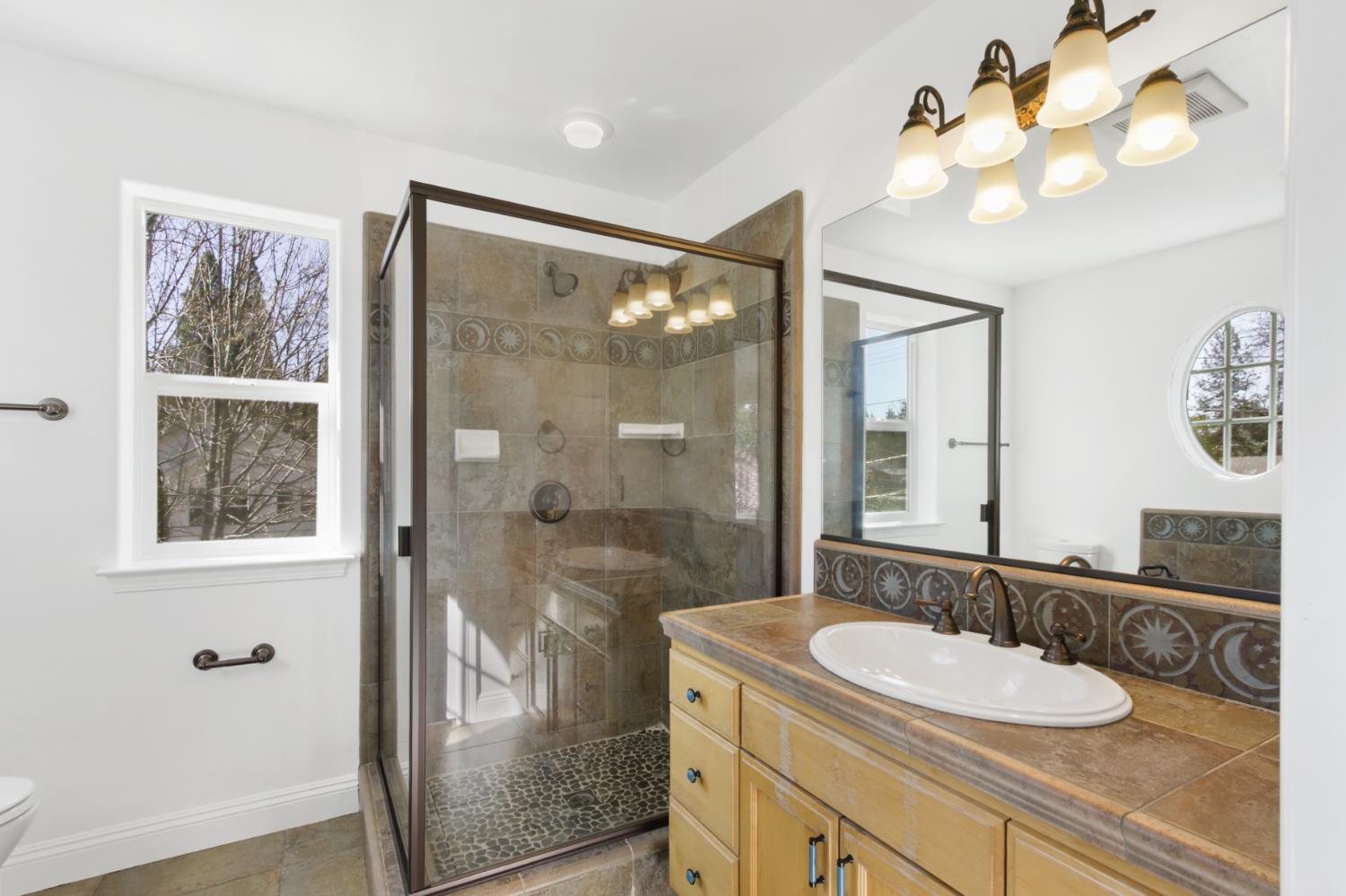 12930 Ridge Road Grass Valley, CA 95945 - Photo 32 of 62 a bathroom with a sink vanity granite and a mirror