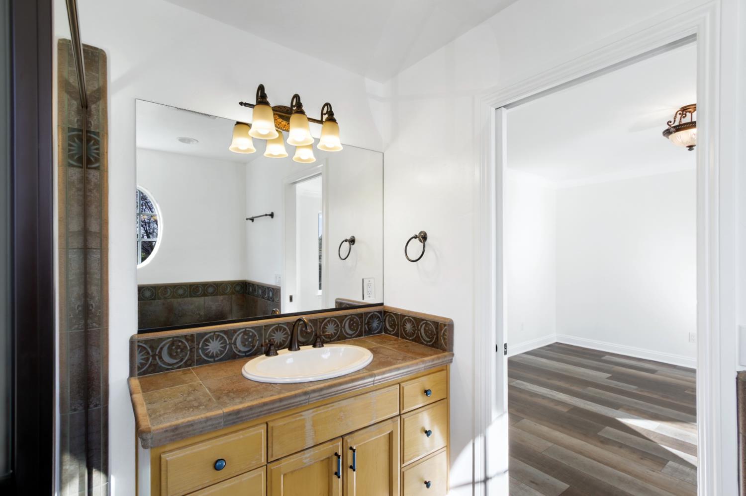 12930 Ridge Road Grass Valley, CA 95945 - Photo 34 of 62 a bathroom with a sink and a mirror