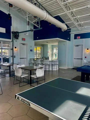 a living room with lots of furniture and a pool table