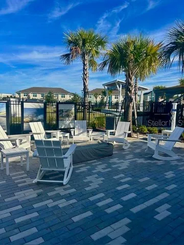 a view of a patio with a table and chairs