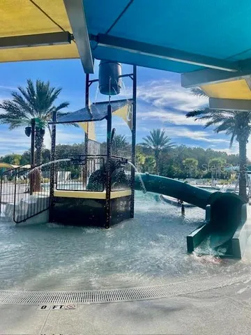 a view of a swimming pool with a patio and a yard