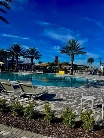 a view of a swimming pool with an outdoor seating
