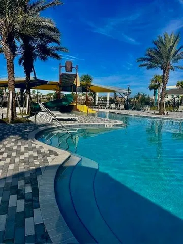 a room with lots of chairs and a chandelier