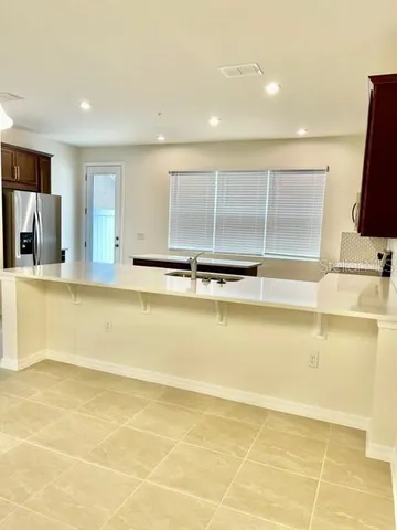a view of kitchen with stainless steel appliances granite countertop sink and cabinets