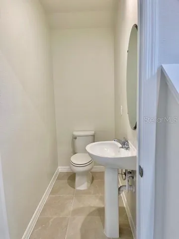 a white toilet sitting next to a bathroom sink