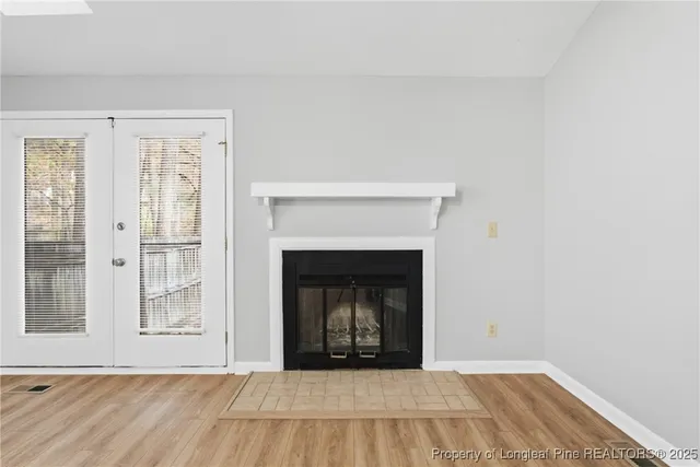 a living room with a fireplace and a fireplace