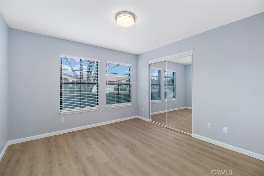 1078 Merrill Circle Hemet, CA 92545 - Photo 14 of 33 an empty room with wooden floor and windows