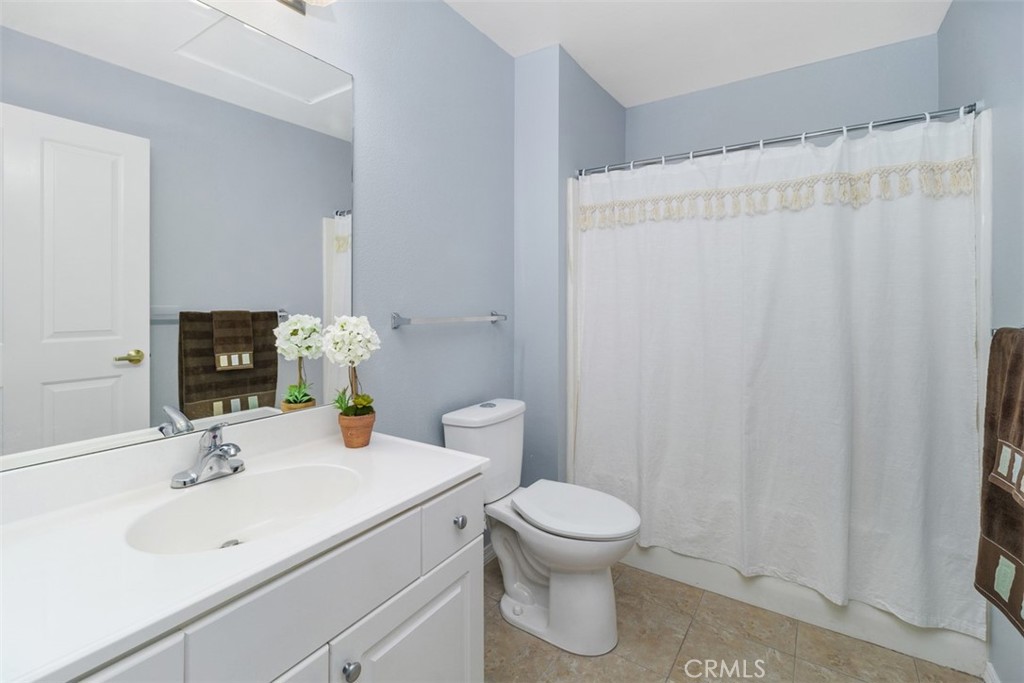 1078 Merrill Circle Hemet, CA 92545 - Photo 16 of 33 a bathroom with a sink a toilet and shower curtain