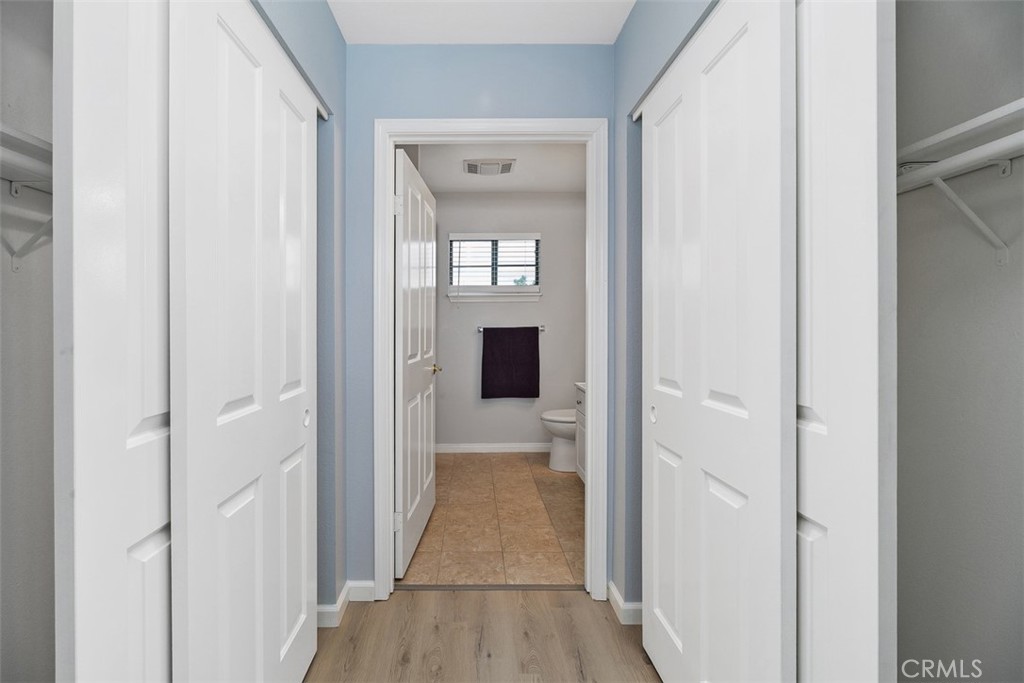 1078 Merrill Circle Hemet, CA 92545 - Photo 21 of 33 a view of a hallway with wooden floor and a hallway