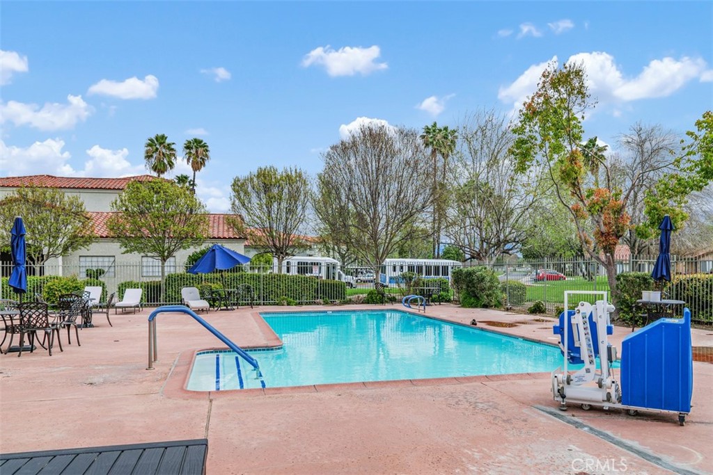 1078 Merrill Circle Hemet, CA 92545 - Photo 30 of 33 a view of a swimming pool with a patio and a yard