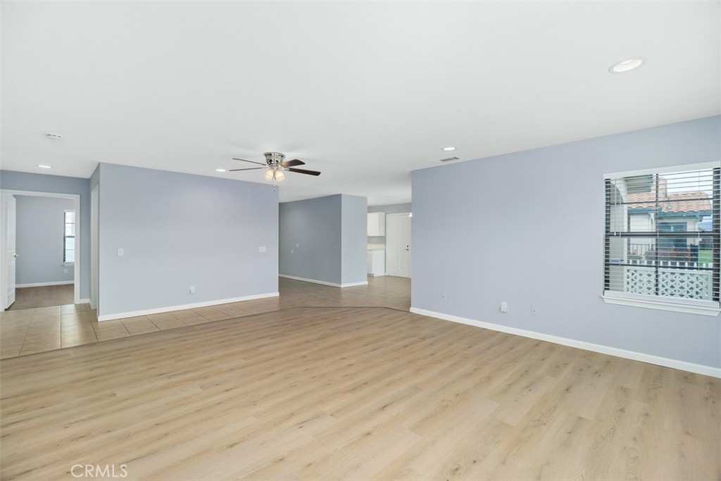 1078 Merrill Circle Hemet, CA 92545 - Photo 8 of 33 a view of an empty room with wooden floor and a window