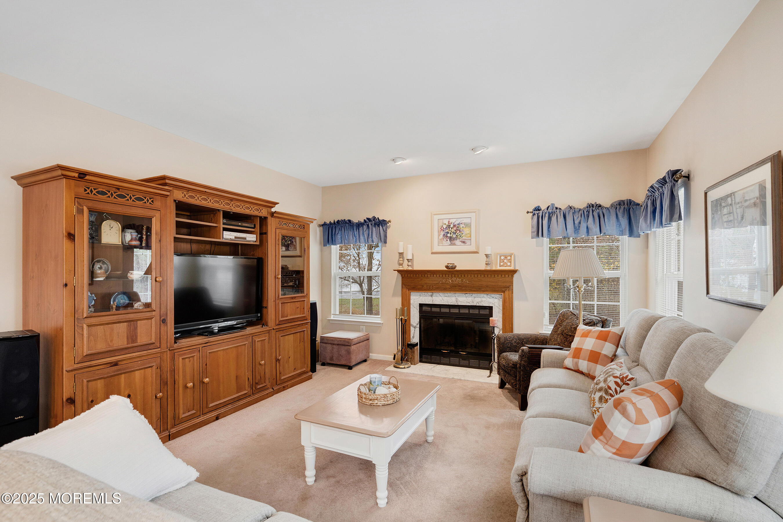 18 Serendipity Drive Jackson, NJ 08527 - Photo 17 of 46 a living room with furniture a flat screen tv and a fireplace