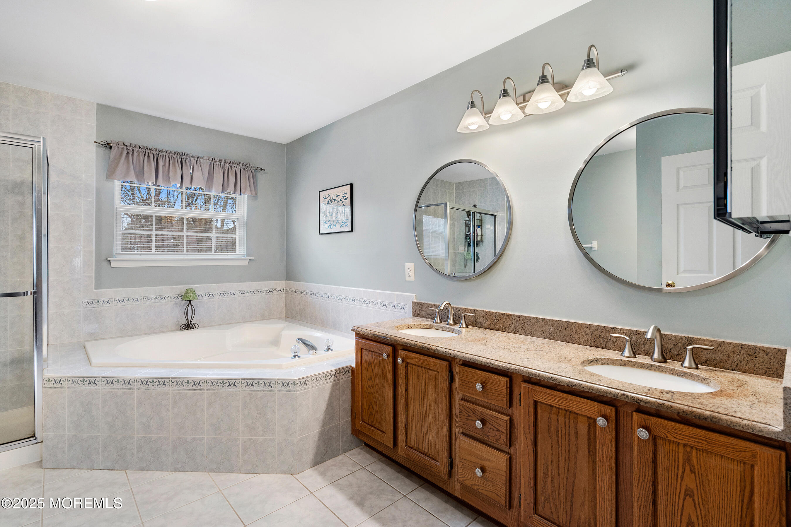 18 Serendipity Drive Jackson, NJ 08527 - Photo 25 of 46 a bathroom with a tub double vanity sink and a large mirror