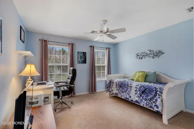 a bedroom with a bed a desk and chair