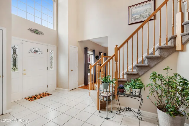 a view of entryway with wooden floor and stairs