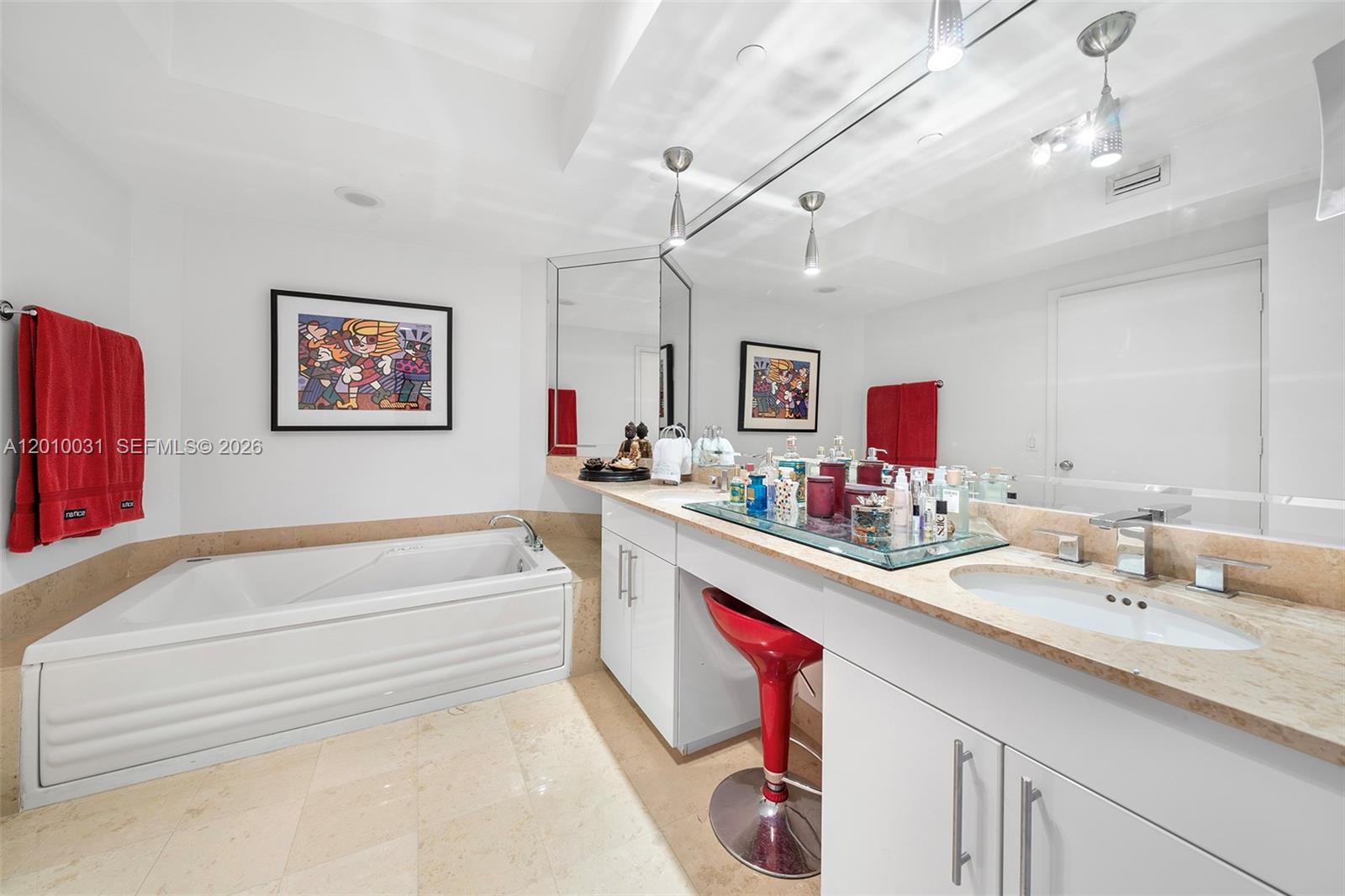 4779 Collins Avenue, Unit 2404 Miami Beach, FL 33140 - Photo 11 of 26 a spacious bathroom with a sink double vanity granite tub and a mirror