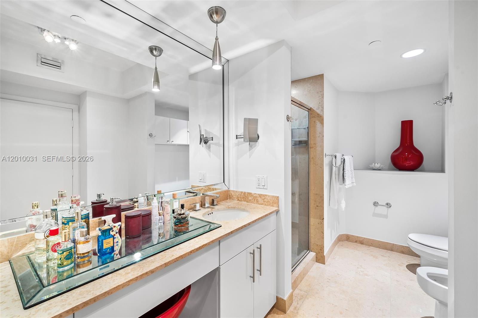 4779 Collins Avenue, Unit 2404 Miami Beach, FL 33140 - Photo 12 of 26 a bathroom with a sink a vanity and a shower