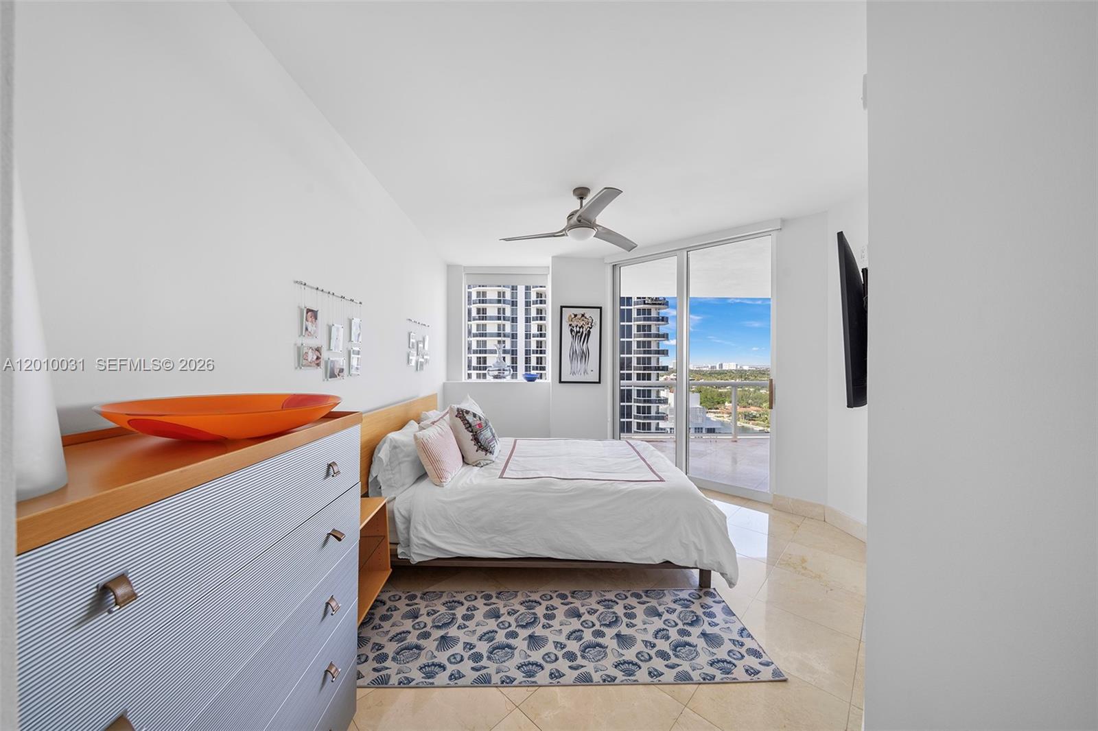 4779 Collins Avenue, Unit 2404 Miami Beach, FL 33140 - Photo 13 of 26 a spacious bedroom with a bed and a window
