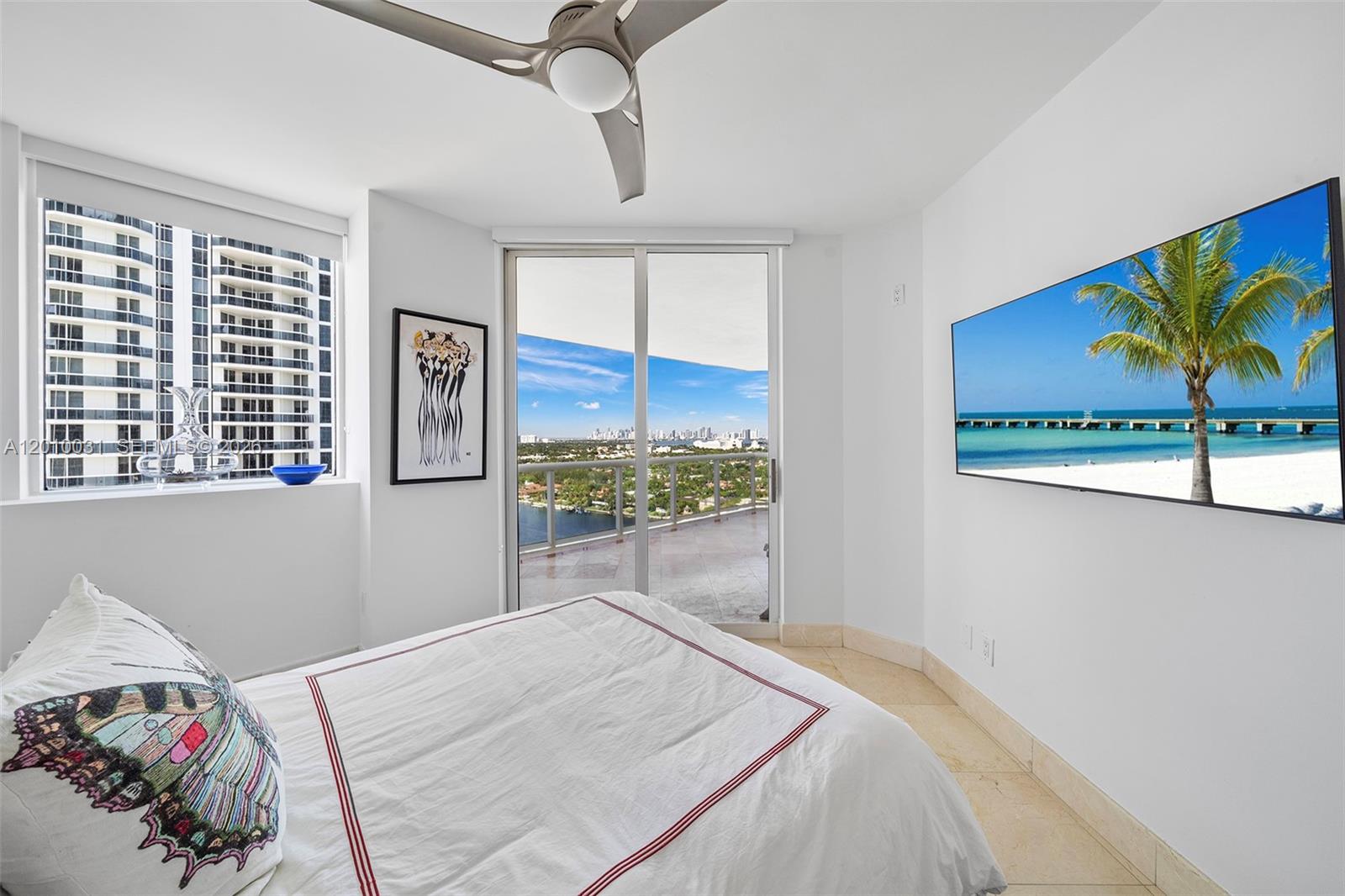 4779 Collins Avenue, Unit 2404 Miami Beach, FL 33140 - Photo 14 of 26 a bedroom with a bed and a painting on the wall