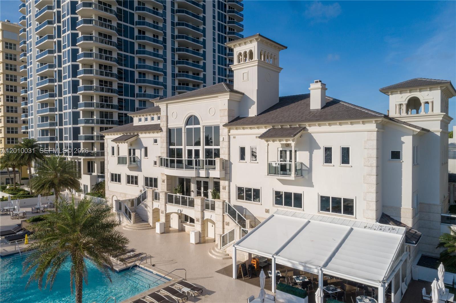 4779 Collins Avenue, Unit 2404 Miami Beach, FL 33140 - Photo 24 of 26 front view of a building with a table and chairs