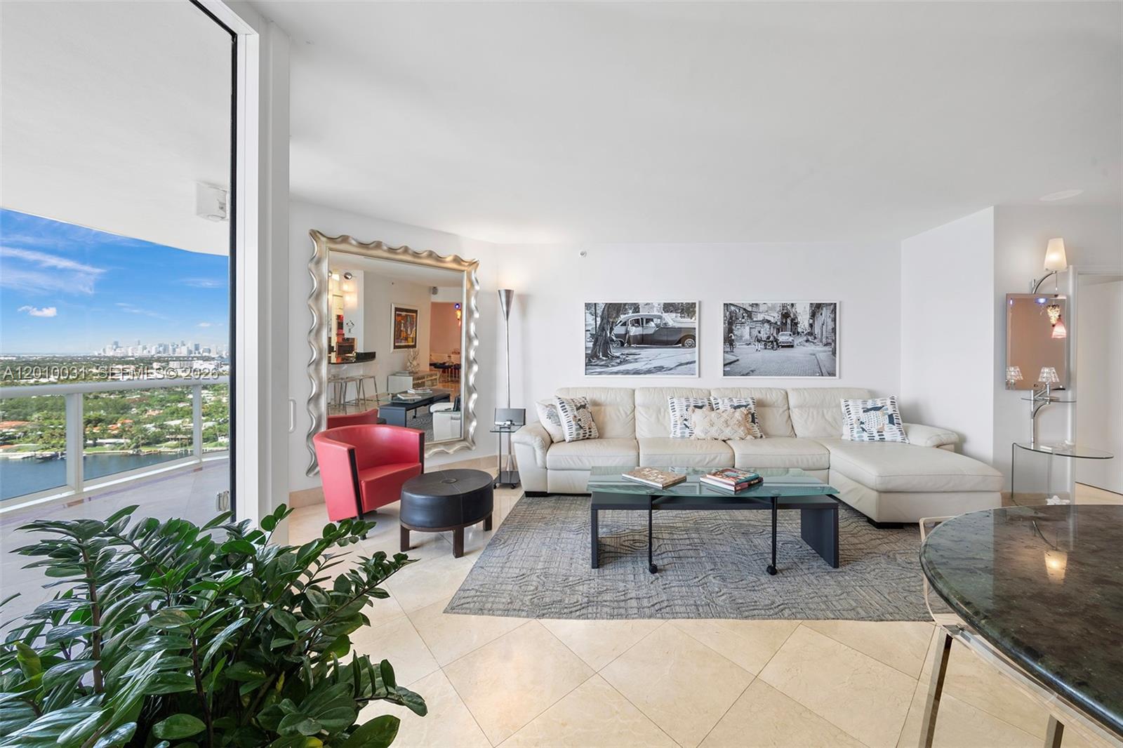 4779 Collins Avenue, Unit 2404 Miami Beach, FL 33140 - Photo 3 of 26 a living room with furniture floor to ceiling window and a floor to ceiling window
