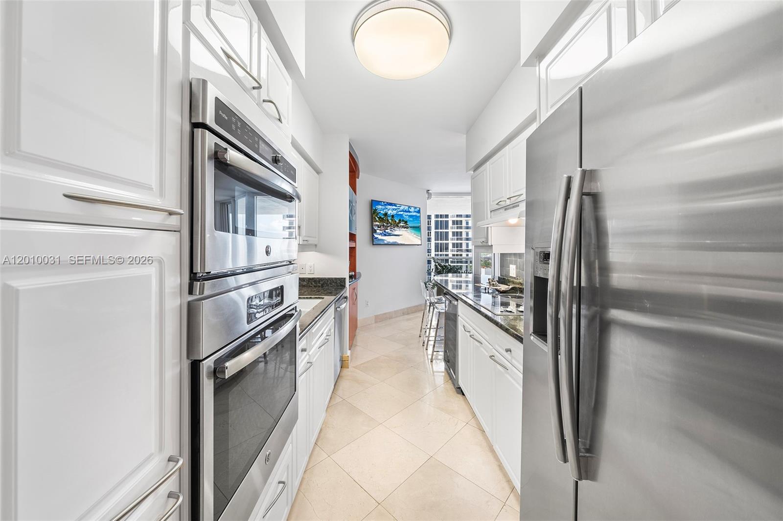 4779 Collins Avenue, Unit 2404 Miami Beach, FL 33140 - Photo 4 of 26 a kitchen with stainless steel appliances granite countertop a refrigerator and a stove