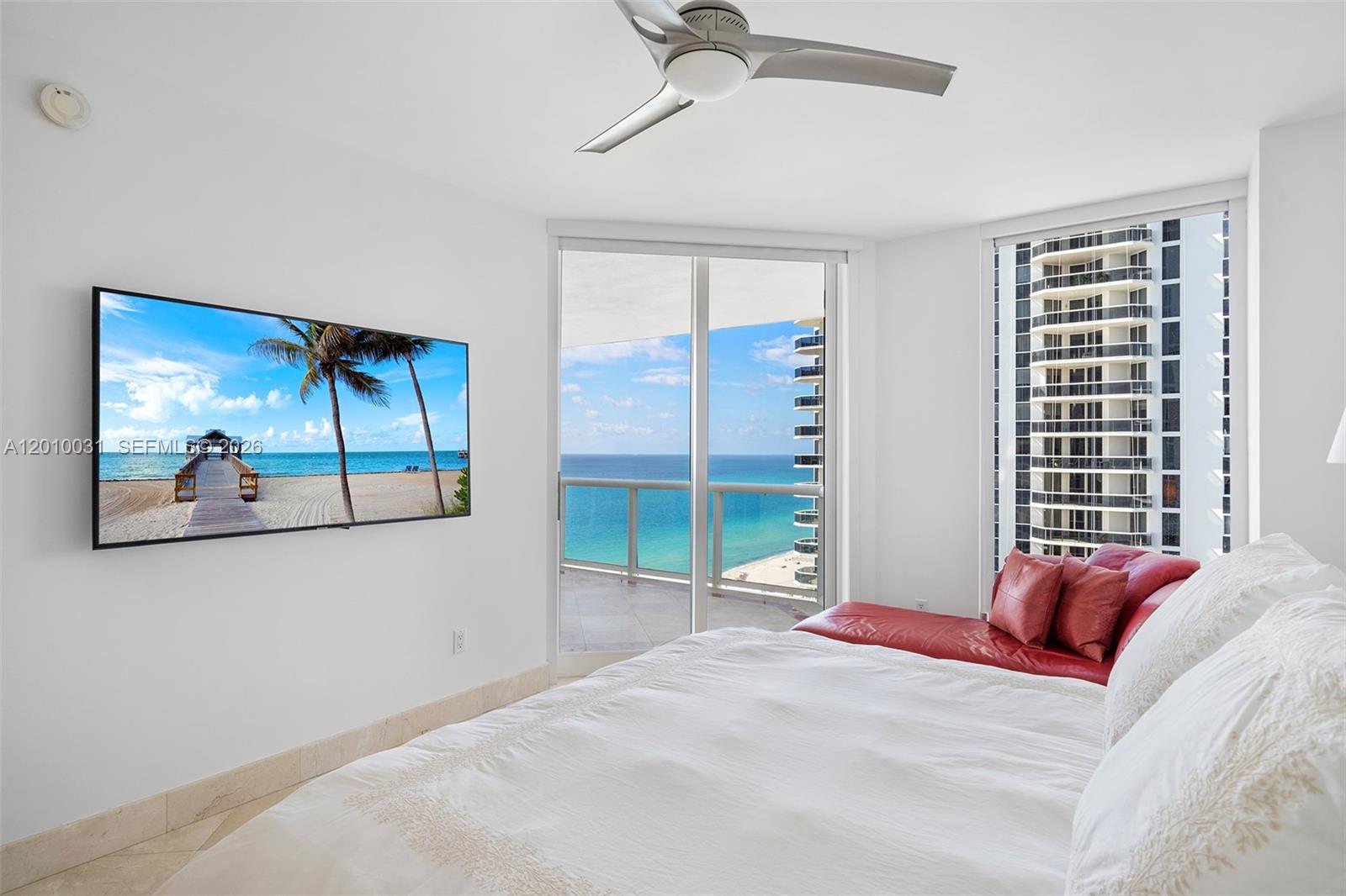 4779 Collins Avenue, Unit 2404 Miami Beach, FL 33140 - Photo 8 of 26 a bedroom with a bed and a painting on the wall