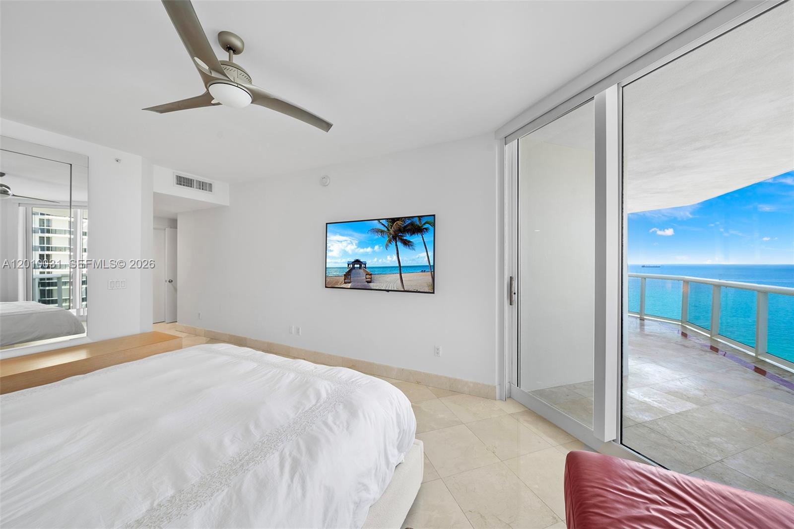 4779 Collins Avenue, Unit 2404 Miami Beach, FL 33140 - Photo 9 of 26 a bedroom with a bed and a painting on the wall