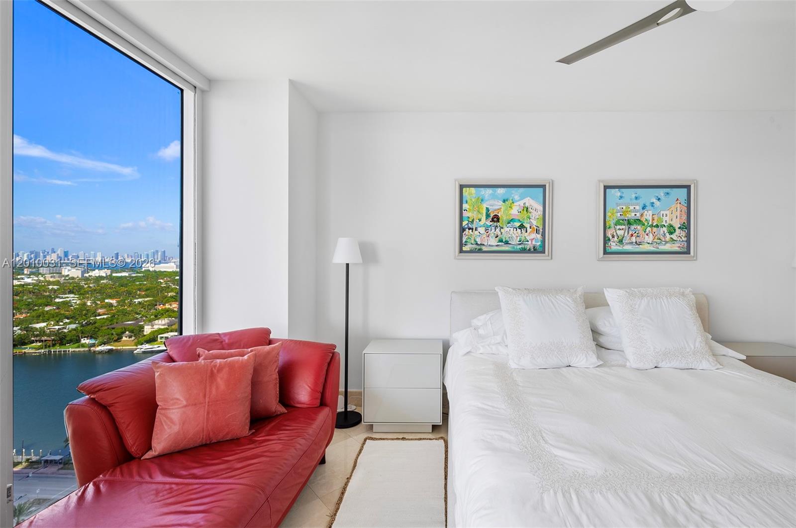 4779 Collins Avenue, Unit 2404 Miami Beach, FL 33140 - Photo 10 of 26 a bedroom with furniture and a large window