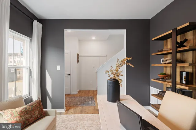 a living room with furniture and a book shelf