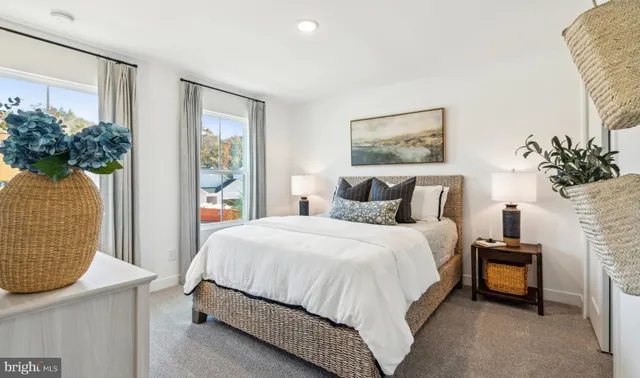 a bedroom with a bed and a potted plant