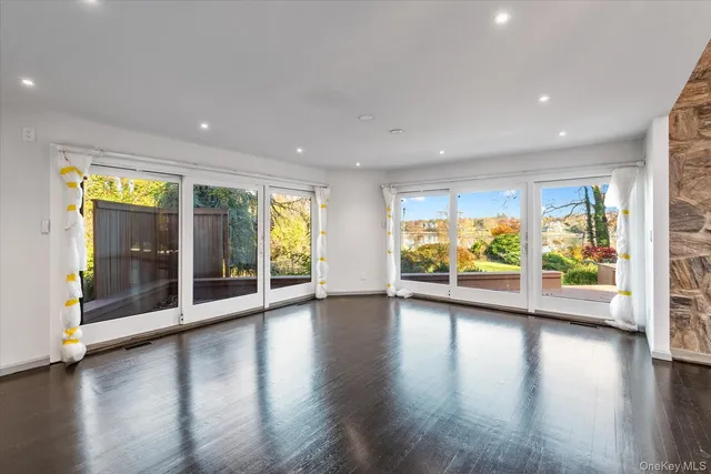 a view of room with wooden floor and windows