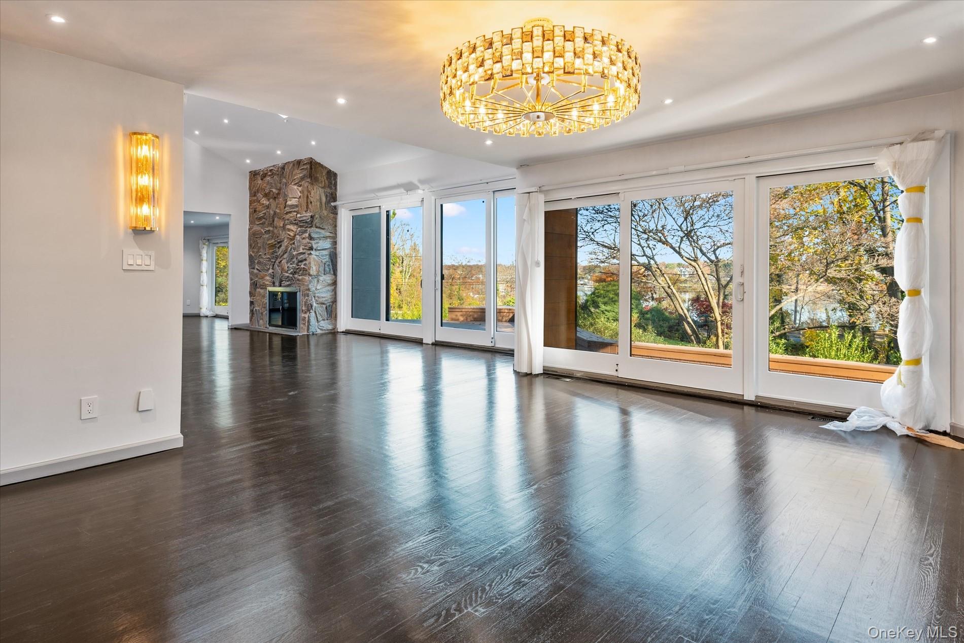 369 East Shore Road Great Neck, NY 11023 - Photo 13 of 50 an empty room with wooden floor and windows